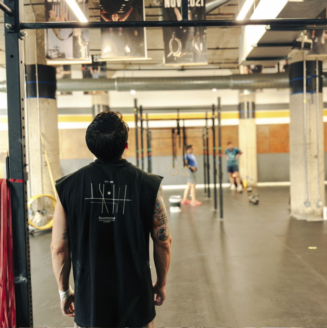 Member in a Ravenswood Chicago tank top looking out over the gym floor