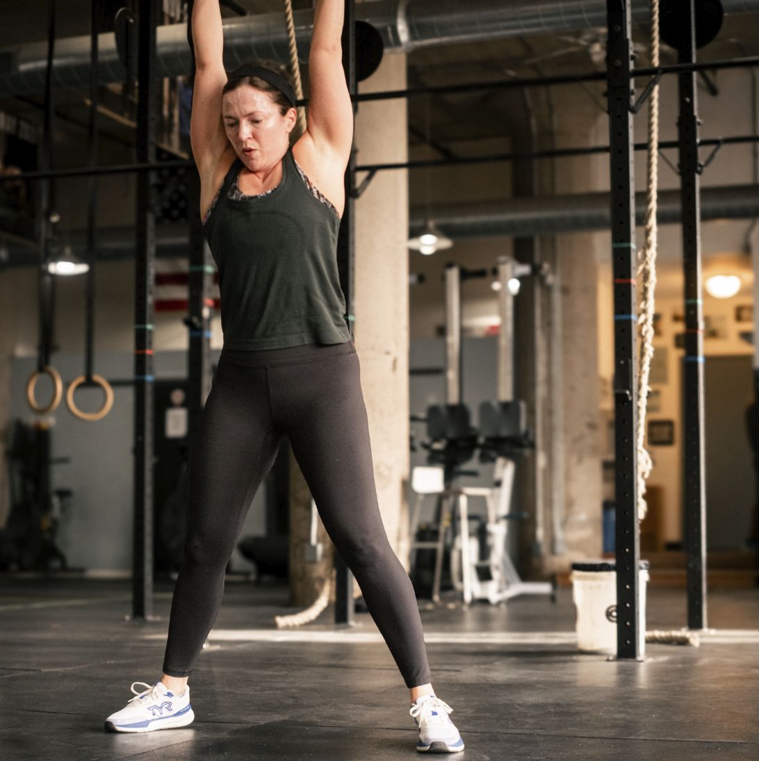 Member hanging from the pull-up rig during a WC WOD class